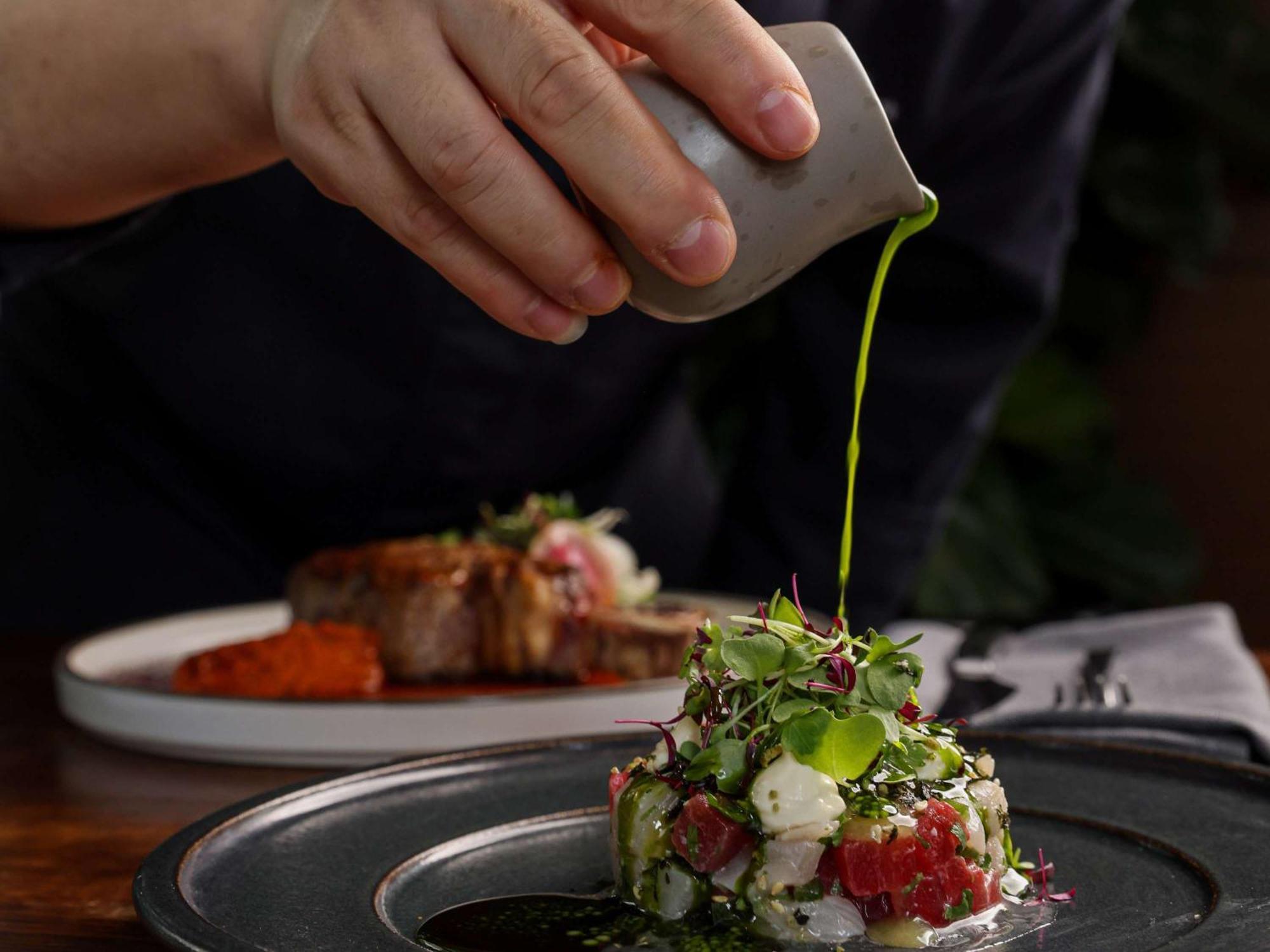 Pullman Sydney Olympic Park Sidney Exterior foto A chef seasoning a dish
